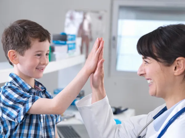 doctor-and-boy-doing-high-five-in-clinic-2026-01-09-09-11-44-utc-69b7ee19d24c4