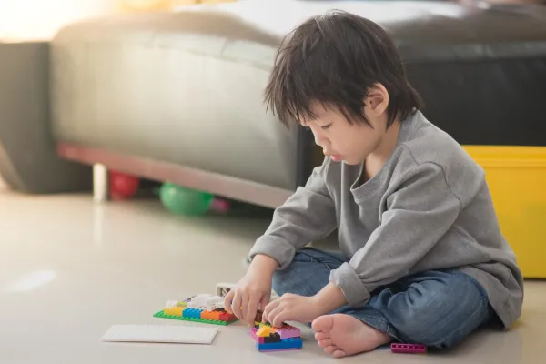 little-asian-child-playing-with-colorful-construct-2026-01-11-10-29-39-utc-69b7edd37777b